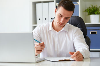 Young businessman signs a document